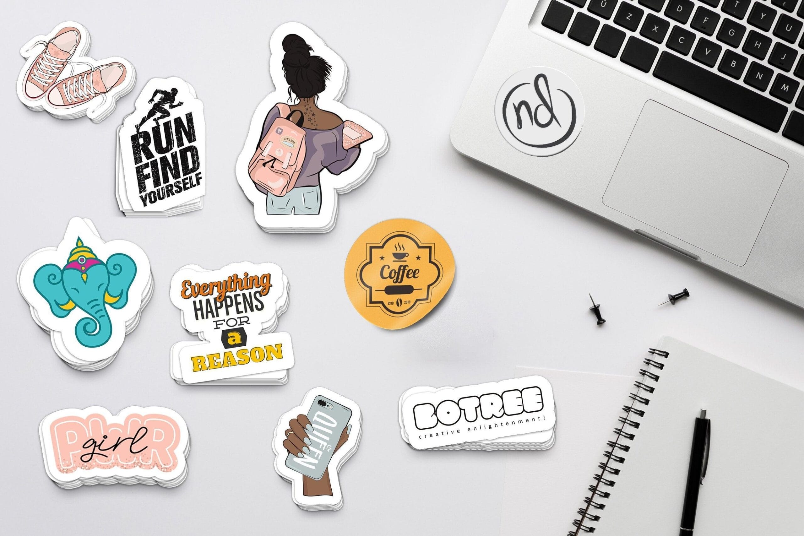 Custom die-cut stickers and vinyl sticker printing samples displayed on a desk for branding and promotional use in Gurgaon and Gurugram.